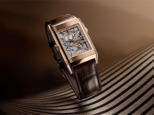 Luxury watch with a skeletonized dial and brown leather strap on an elegant striped surface.