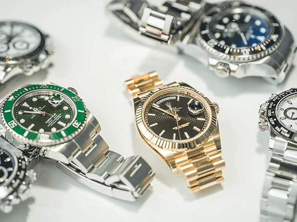 A collection of luxury watches including Rolex models, showcasing premium craftsmanship and designs.
