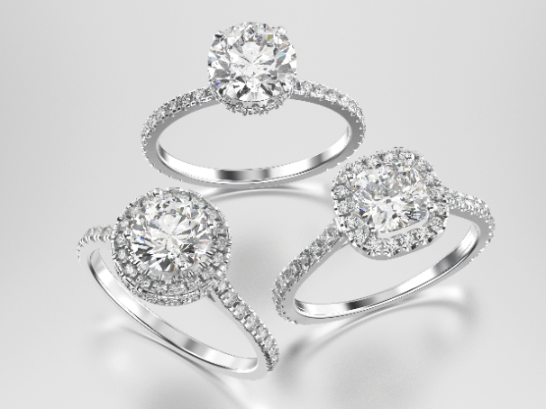 Three diamond engagement rings displayed on a light background, symbolizing jewelry used as collateral for engagement ring loans at Qollateral.