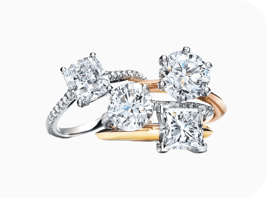 Four diamond engagement rings in gold and platinum settings used as collateral for a loan.