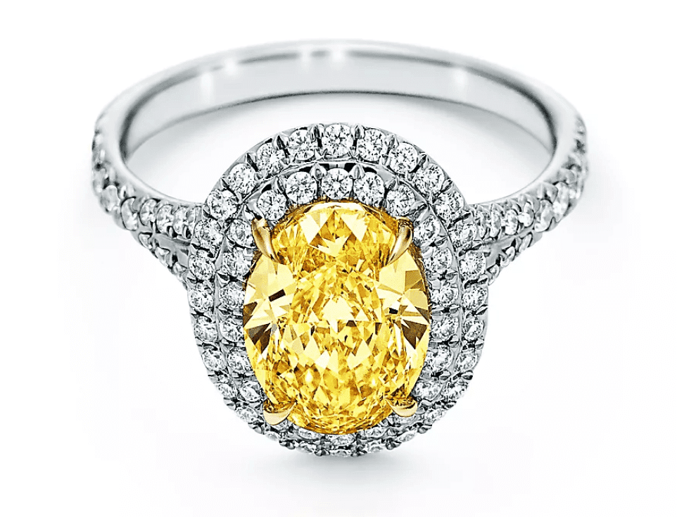 Yellow diamond engagement ring with halo of white diamonds available for collateral loan.