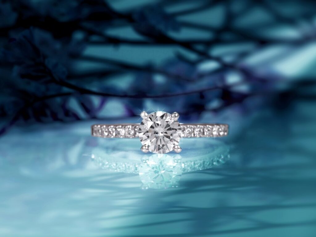 A high-value diamond engagement ring on a reflective surface, used as collateral for a short-term loan at Qollateral.