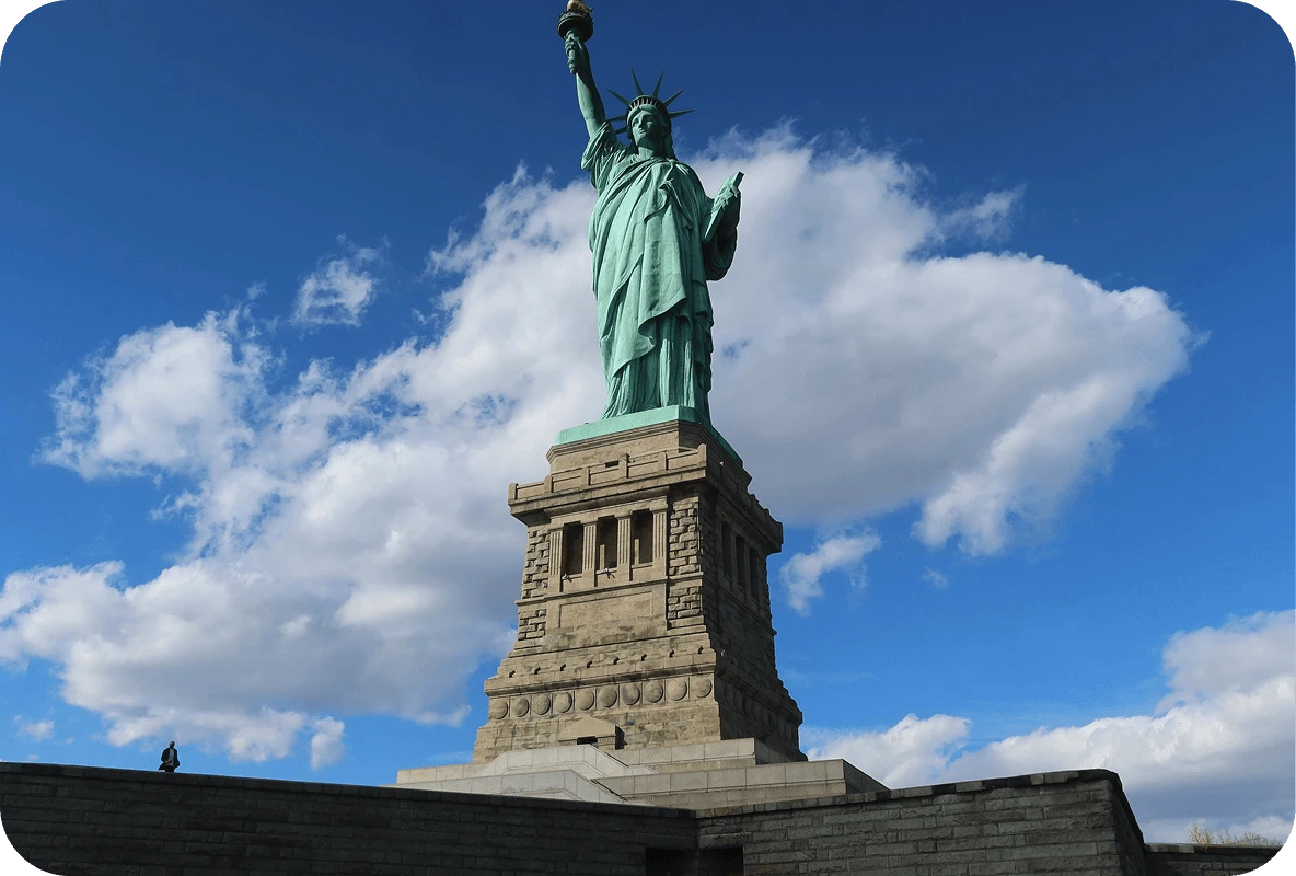 Statue of Liberty with blue sky and scattered clouds in the background