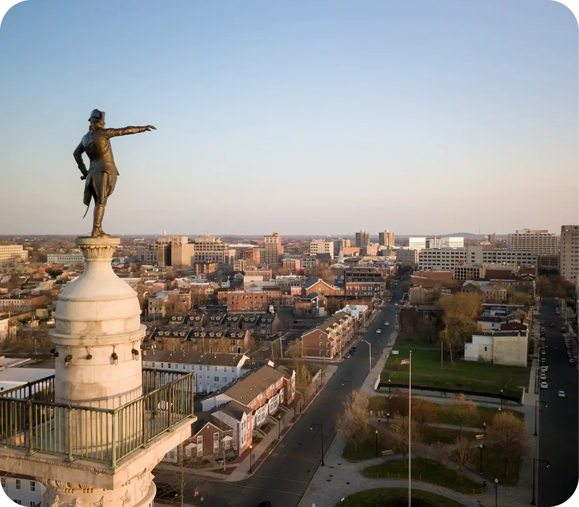 Aerial view of the George Washington Monument in Newark, New Jersey, pointing over the city at sunset