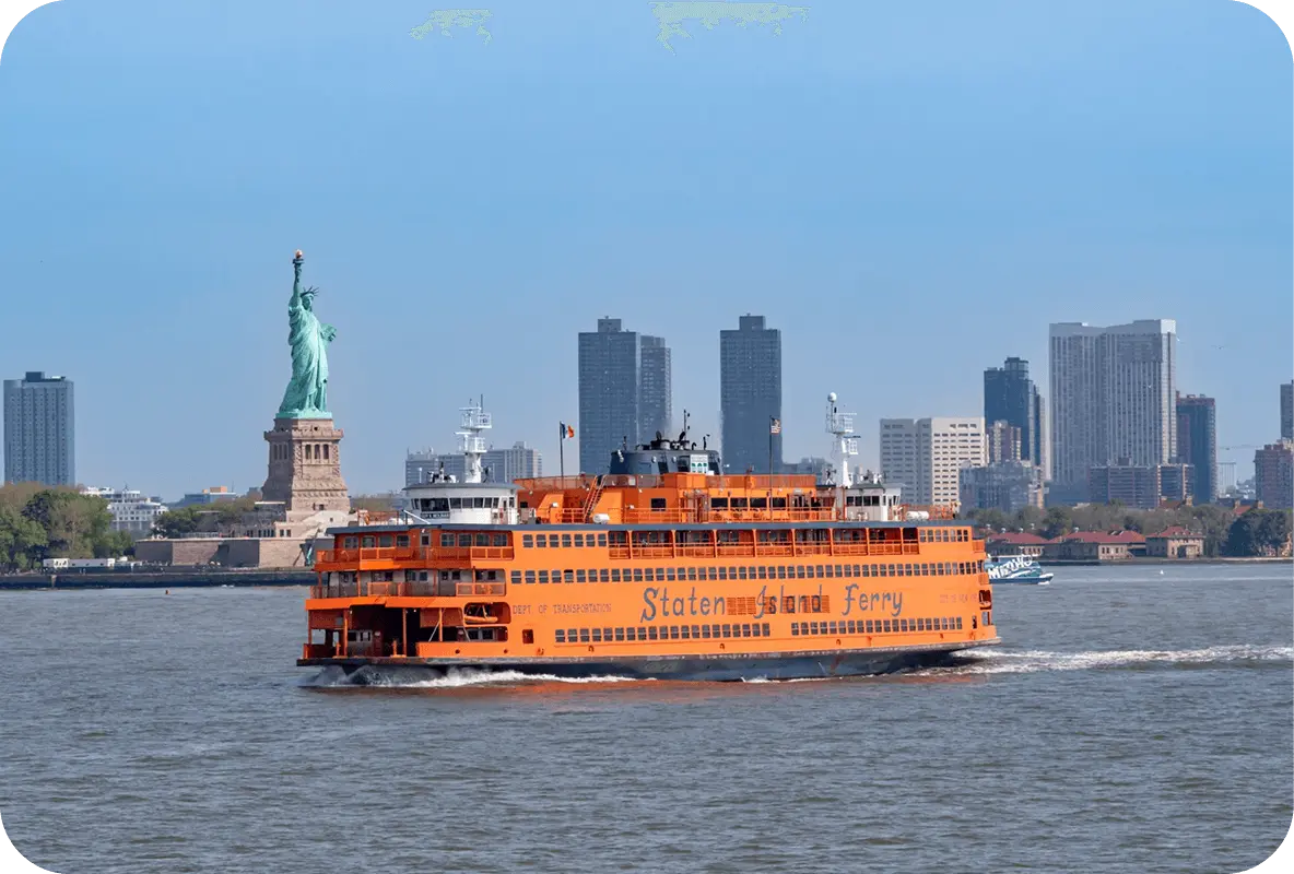 Staten Island Ferry sailing past the Statue of Liberty with Manhattan skyline in the background