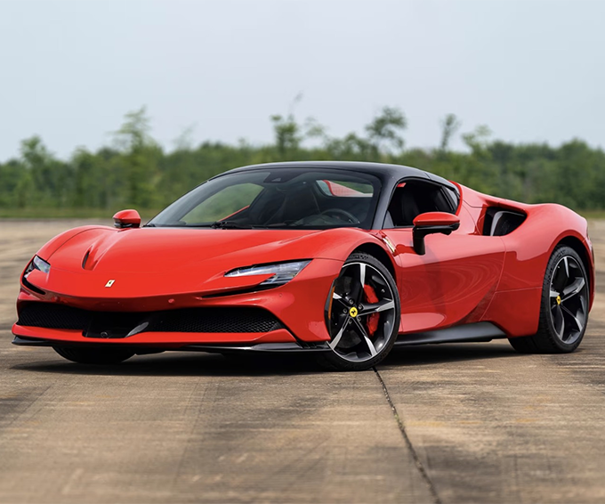 Red Ferrari SF90 Stradale supercar parked on a paved surface